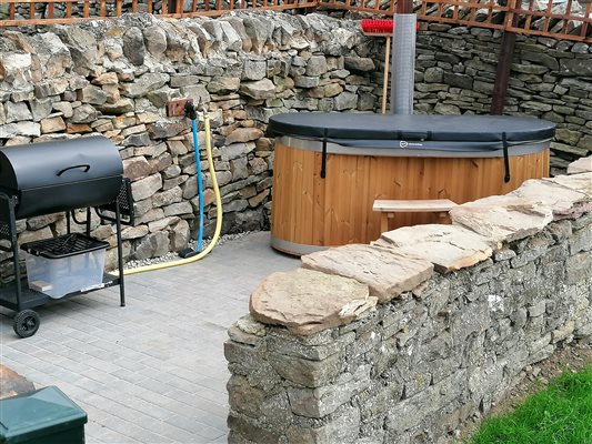 private patio with BBQ and wood fired hot tub