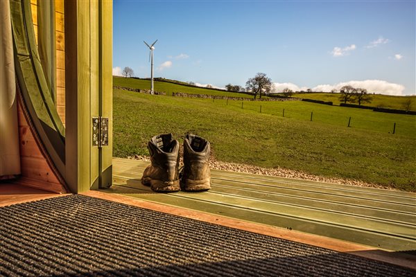 walking boots in front of glamping pod