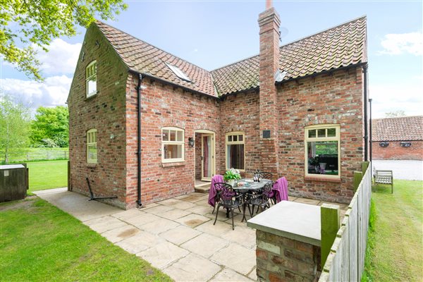 brick cottage with garden table