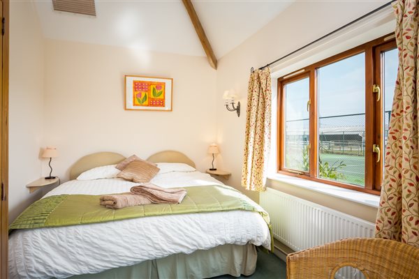 Super King Bedroom in Cider Mill Cottage overlooking the tennis court