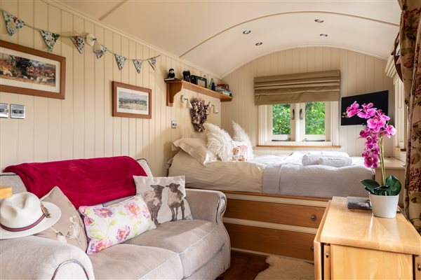 Shepherds hut with country cottage interior, king size bed and sofa