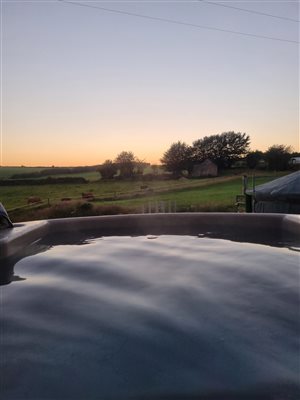 Relax in the wood fired hot tub, with a view of the cows