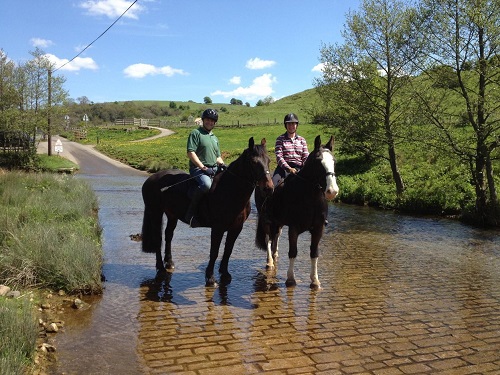 Riders crossing shallow water