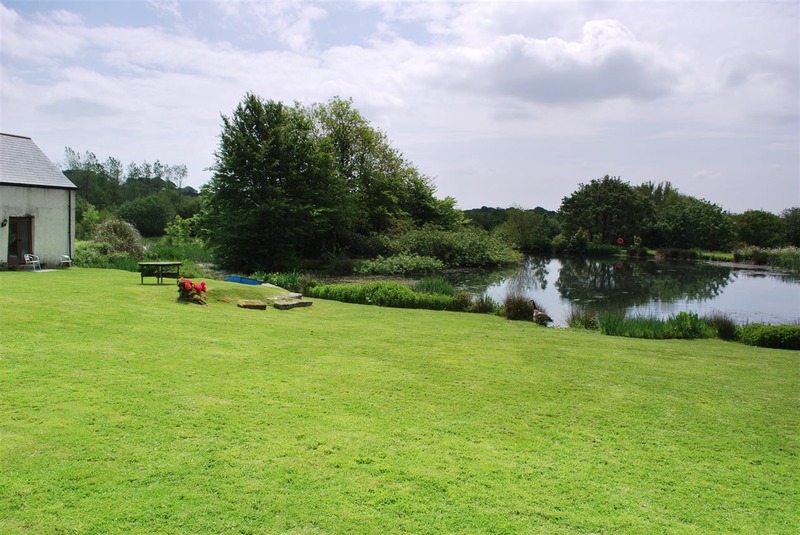 Polhilsa Farm in Cornwall, offering bed and breakfast and self-catering cottages with access to two fishing lakes stocked with carp, roach, and rudd. Guests can enjoy a full Cornish breakfast before a day's fishing in a tranquil countryside setting.