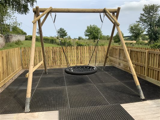 Play area with swing