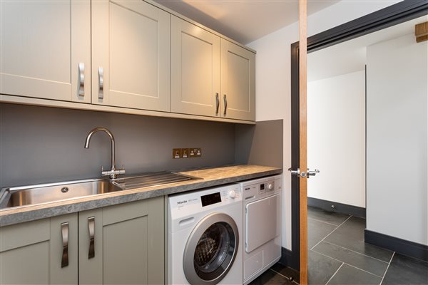 Utility room with washing machine and tumble dryer