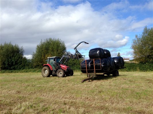 tractor loading silage bales