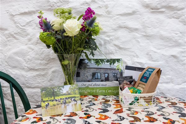 welcome book and flowers on dining table