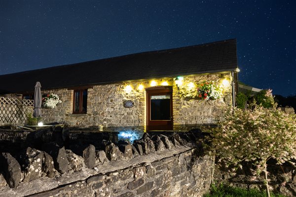 Swallow Cottage outside at night