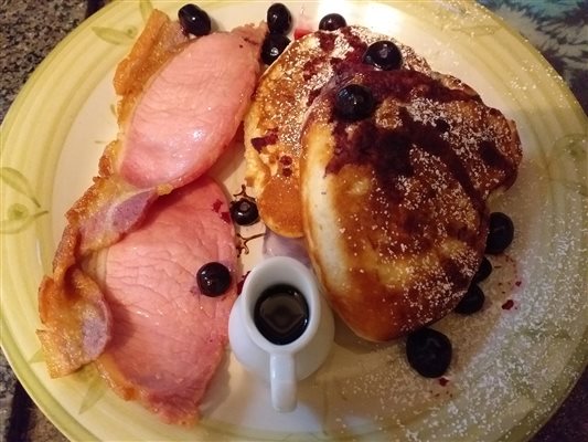 American pancakes with bacon, maple syrup and blueberries
