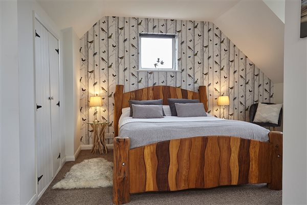 Rowborough Cottage main bedroom with driftwood bed