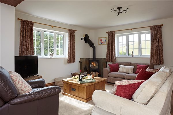Rowborough Cottage sitting-room with woodburner