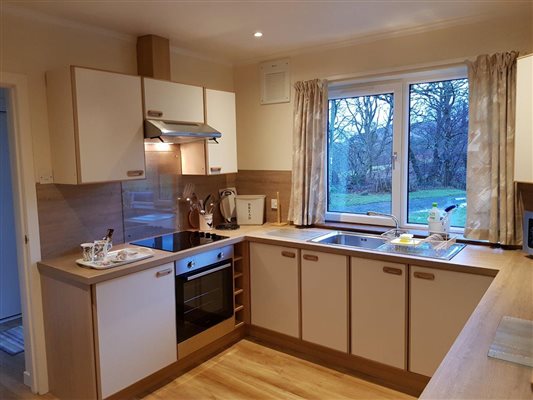 kitchen in holiday cottage with hob, oven, sink and microwave