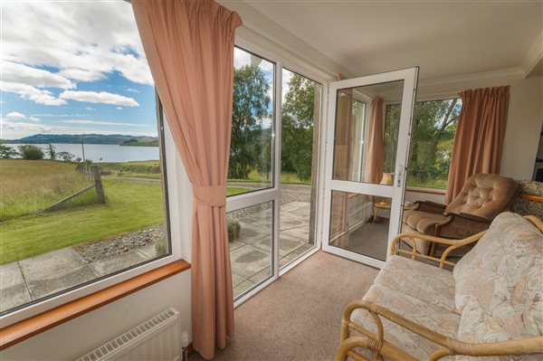 seating with windows to the countryside, loch and clouds