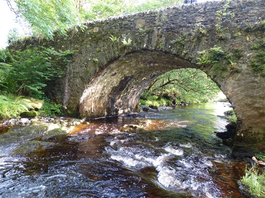 old stone bridge with water running under it