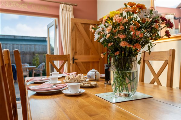 dining table set for afternoon tea with flowers