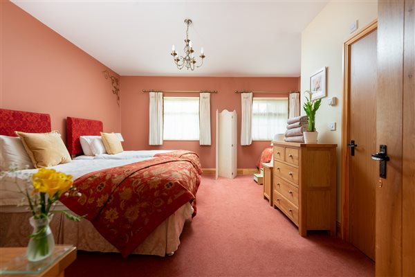 large bedroom with 3 single beds