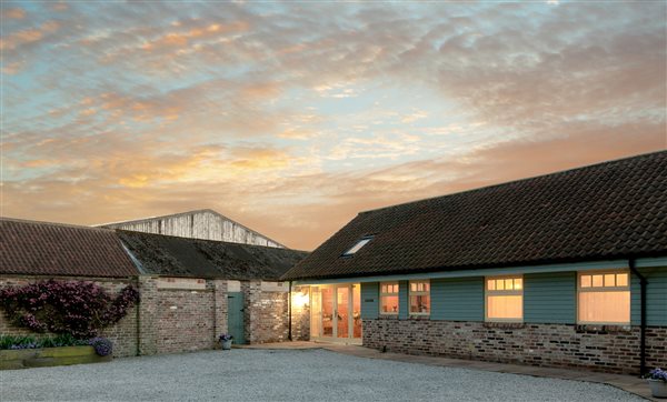 cottage lit up at dusk