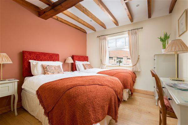 twin beds in a room with beams