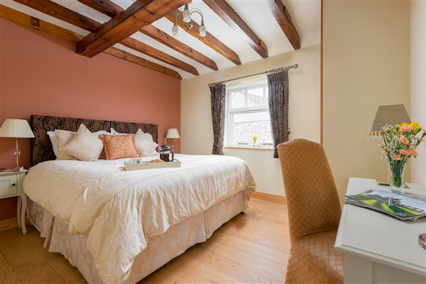 large bed in a roon with beams