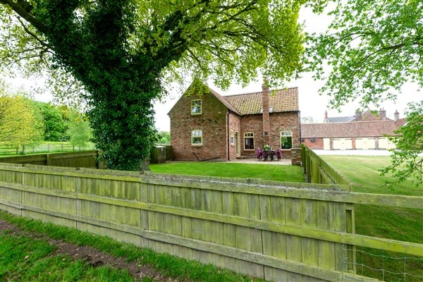 detached brick built house with garden