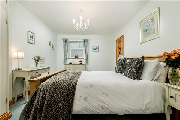 large oak bed in master bedroom