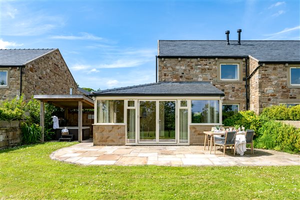 Enclosed garden area with covered hot tub