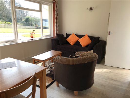 Lounge showing 3 seater sofa and wood laminate floor