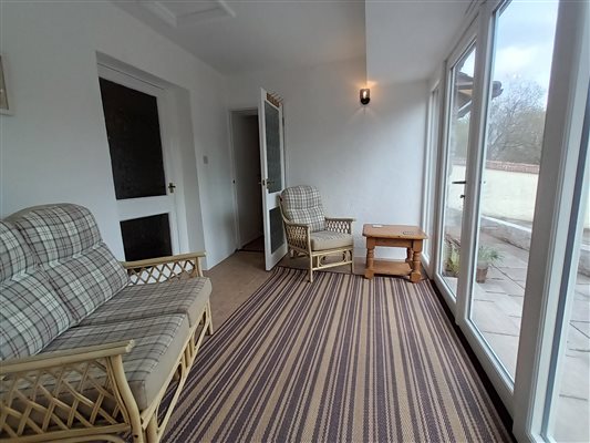 Shippon sun room leading onto patio