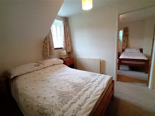 Threshing Barn double bedroom showing door to twin