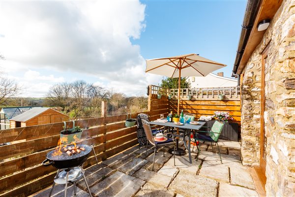 Enclosed courtyard garden with garden furniture and BBQ