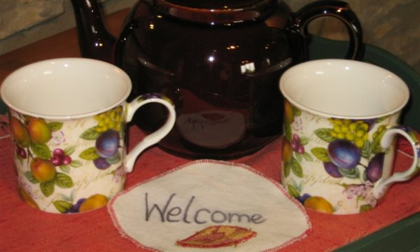 teapot and mugs welcome