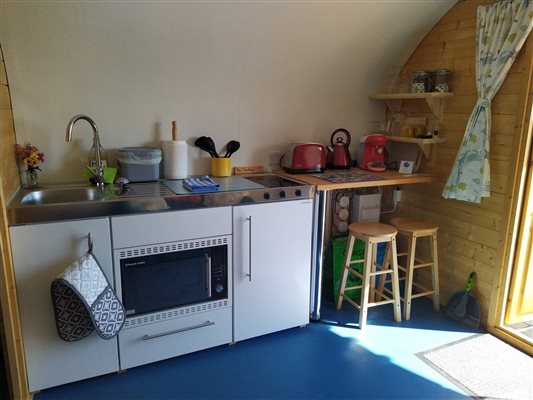 accommodation, glamping, kitchenette, fridge freezer, oven, hob, seating, worktop, sink, Essex, UK