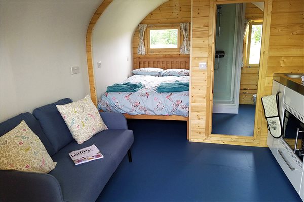 Inside Marsh Harrier Glamping pod. Bed, sofa, ensuite and kitchenette Inside Marsh Harrier Glamping pod. Bed, sofa, ensuite and kitchenette