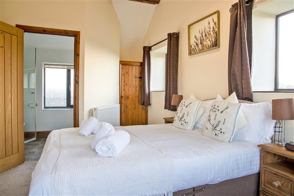 large double bedroom with en-suite shower room and countryside view