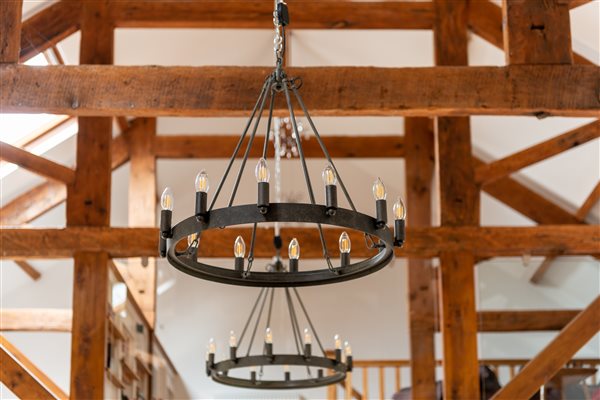 vaulted ceiling with wooden beams and chandelier lights