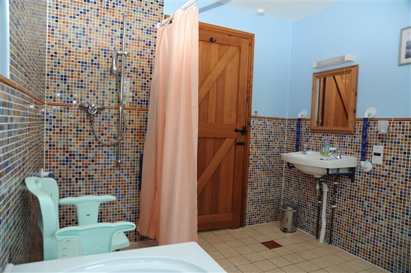 wet floor bathroom with walk/roll in shower and double ended bath