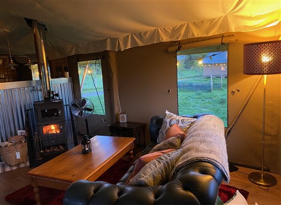 log burning stove and chesterfield sofa in a cosy room