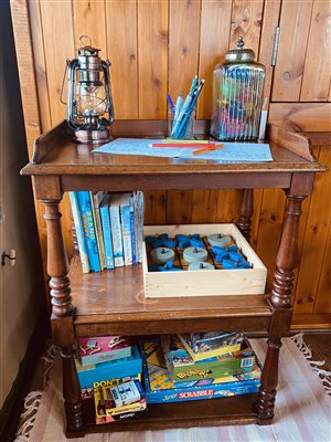 Board games and books on a bookshelf