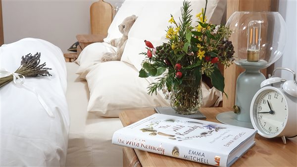 Snuggle down in deep feather bedding dressed with organic cotton linen for a cosy night's sleep