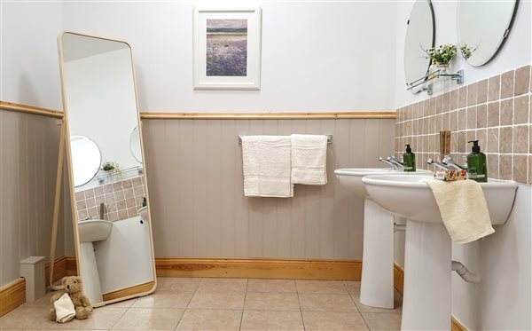 The shower room with his and her's wash basins