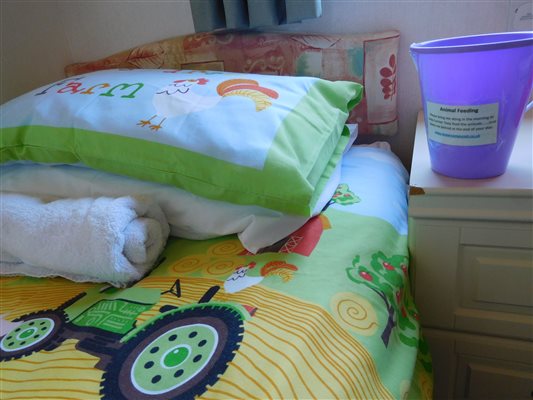 Farm bedding with animal feeding bucket