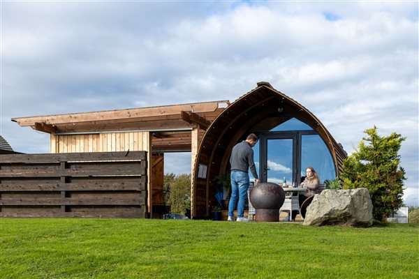 Luxury glamping pod at Galloway Retreats with a private outdoor seating area, modern curved design and spacious green lawn in a peaceful countryside setting. Luxury glamping pod at Galloway Retreats with a private outdoor seating area, modern curved design and spacious green lawn in a peaceful countryside setting.