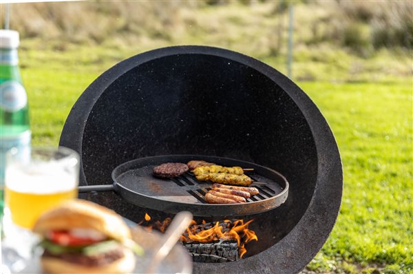 Outdoor BBQ at Galloway Retreats, featuring a wood-fired grill cooking delicious food, perfect for relaxed alfresco dining during a luxury countryside getaway. Outdoor BBQ at Galloway Retreats, featuring a wood-fired grill cooking delicious food, perfect for relaxed alfresco dining during a luxury countryside getaway.