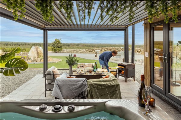 Luxury cabin terrace with outdoor dining area, private hot tub and countryside views at Galloway Retreats, Dumfries and Galloway. Luxury cabin terrace with outdoor dining area, private hot tub and countryside views at Galloway Retreats, Dumfries and Galloway.