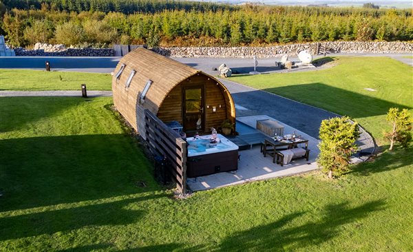 Luxury wooden glamping pod with private outdoor hot tub, patio seating and beautiful countryside surroundings. Luxury wooden glamping pod with private outdoor hot tub, patio seating and beautiful countryside surroundings.