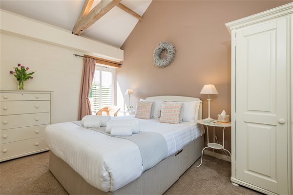 Owls Roost double bedroom with door leading to garden