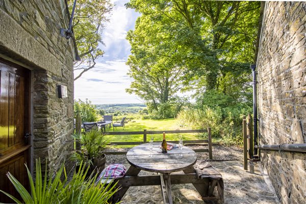 Terrace in private garden with table overlooking rural view