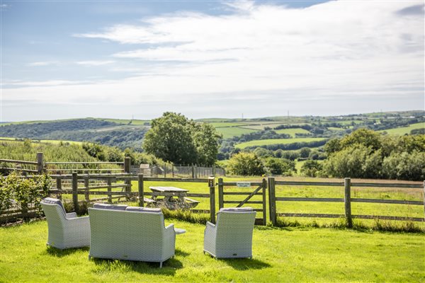 The shared garden with seating area and rural views