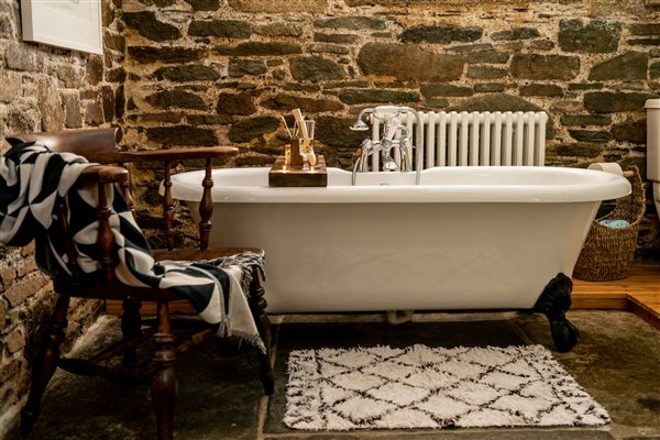 Roll-top bath in a luxury Tredarrup Farm holiday cottage